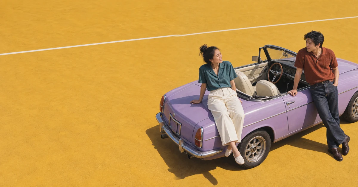 Two people talking beside a purple convertible